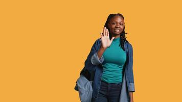 Assertive african american woman doing stop hand gesture and talking. Annoyed girl doing firm halt sign gesturing, wishing to end concept, isolated over studio background, camera B video