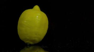 Spinning lemon in slow motion on a black background video