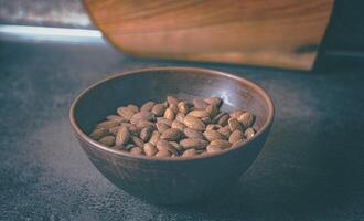 Almonds in a clay plate on the table photo