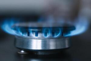 Kitchen burner turns on. Gas is switching on, appearing blue flame photo