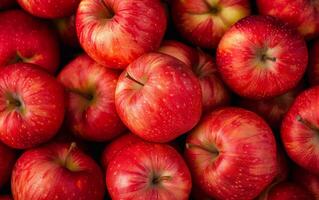 A bunch of red apples are piled on top of each other photo