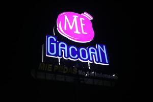 Tasikmalaya, West Java, Indonesia. April 07 2024. -Photo of MIE GACOAN neon box sign pole at night photo