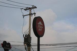 Tasikmalaya, West Java, Indonesia. April 06 2024. -Photo of PIZZA HUT neon box sign pole photo