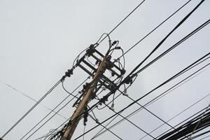 Photo of utility poles, electricity poles with messy wires.