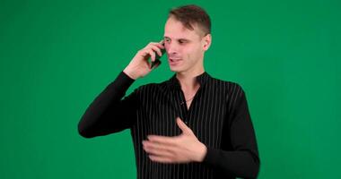 man talking on mobile phone over a green screen background video