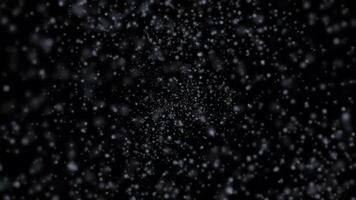 Blizzard winter snowfall particles loop animation background, moving through heavy snowfall, snow particle mist spray loop animated effect on black background video