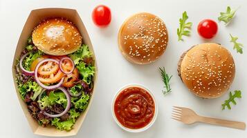 Top view of delicious burger and fresh vegetable ingredients on white background photo