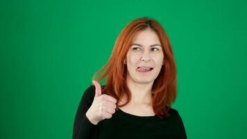 young woman showing thumbs up. The girl is happy and shows that everything is fine. Green screen, chromakey. video