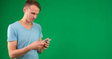 Young promoter man wear shirt white t-shirt point index finger camera on you indicate index finger aside on workspace area copy space mock up isolated on plain pastel green background studio video