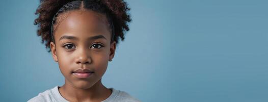 An African American Juvenile Girl Isolated On A Light Blue Background With Copy Space. photo