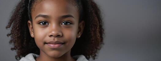 An African American Juvenile Girl Isolated On A Grey Background With Copy Space. photo