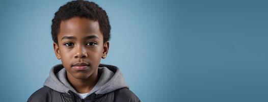 An African American Youngster Boy Isolated On A Ice Blue Background With Copy Space. photo