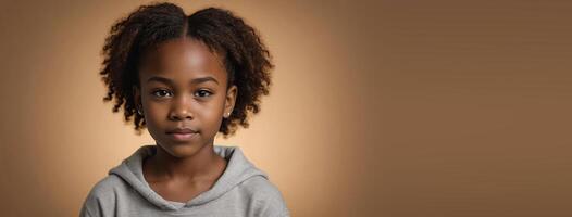 An African American Juvenile Girl Isolated On A Amber Background With Copy Space. photo