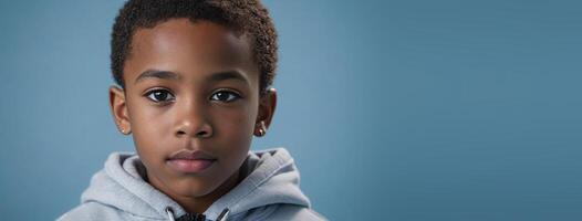 An African American Kinfolk Boy Isolated On A Ice Blue Background With Copy Space. photo