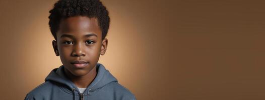 An African American Youngster Boy Isolated On A Amber Background With Copy Space. photo