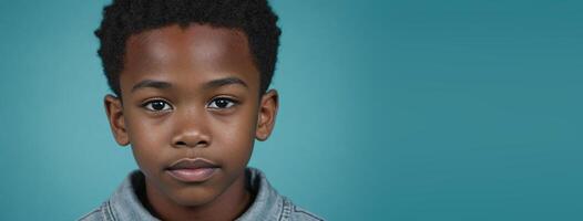 An African American Youthful Boy Isolated On A Turquoise Background With Copy Space. photo