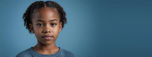 An African American Juvenile Girl Isolated On A Blue Background With Copy Space. photo