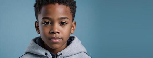 An African American Youthful Boy Isolated On A Ice Blue Background With Copy Space. photo