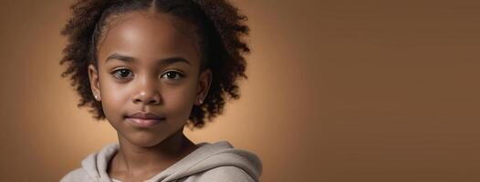 An African American Youngster Girl Isolated On A Amber Background With Copy Space. photo