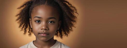 An African American Juvenile Girl Isolated On A Amber Background With Copy Space. photo