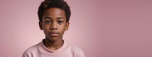 An African American Juvenile Boy Isolated On A Pink Background With Copy Space. photo