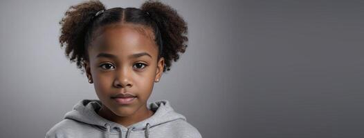 An African American Juvenile Girl Isolated On A Silver Background With Copy Space. photo