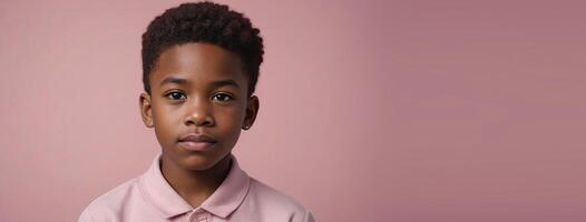 An African American Juvenile Boy Isolated On A Pink Background With Copy Space. photo