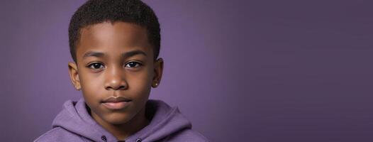 An African American Juvenile Boy Isolated On A Amethyst Background With Copy Space. photo