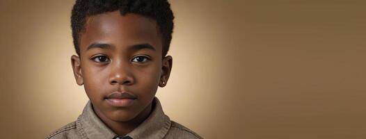 An African American Juvenile Boy Isolated On A Gold Background With Copy Space. photo