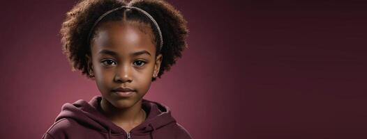 An African American Juvenile Girl Isolated On A Ruby Background With Copy Space. photo