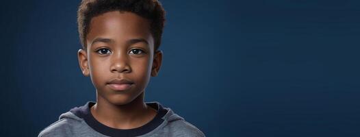 An African American Juvenile Boy Isolated On A Sapphire Background With Copy Space. photo