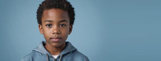 An African American Juvenile Boy Isolated On A Light Blue Background With Copy Space. photo