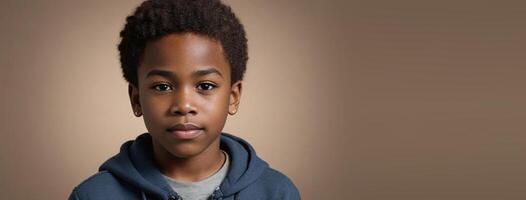 An African American Juvenile Boy Isolated On A Hazel Background With Copy Space. photo