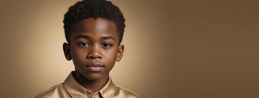 An African American Juvenile Boy Isolated On A Gold Background With Copy Space. photo