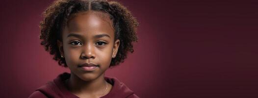 An African American Youngster Girl Isolated On A Ruby Background With Copy Space. photo