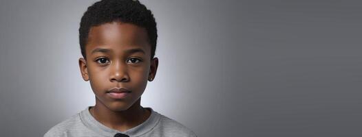 An African American Juvenile Boy Isolated On A Silver Background With Copy Space. photo