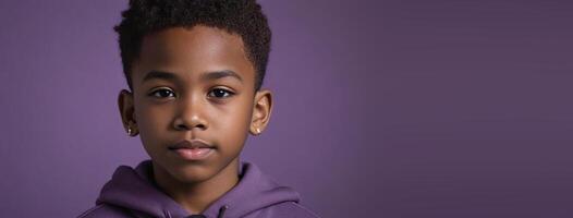 An African American Juvenile Boy Isolated On A Purple Background With Copy Space. photo