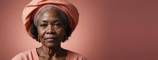 African American 70S Elderly Woman Isolated On A Coral Background With Copy Space. photo