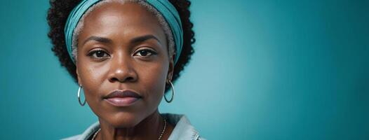 African American 60S Elderly Woman Isolated On A Turquoise Background With Copy Space. photo