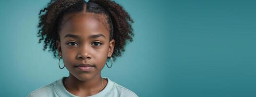 An African American Juvenile Girl Isolated On A Turquoise Background With Copy Space. photo