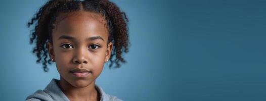 An African American Juvenile Girl Isolated On A Blue Background With Copy Space. photo