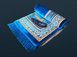 Folded Muslim prayer mat used to pay on dark background photo