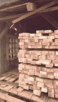 A stack of firewood next to a rustic building video