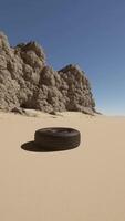 A tire sitting in the middle of a desert video