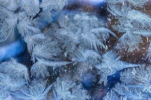 Frost texture on frozen glass in winter. photo