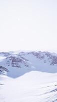 A majestic snow-covered mountain against a clear blue sky video