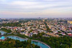 Uzbekistan, Tashkent - September 29, 2023 Top view from the observation deck on the Tashkent TV tower to the central part of the city covered with smog at sunset . Air polution. photo