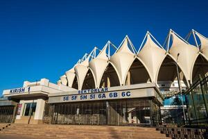 Tashkent, Uzbekistan - September 30, 2023 Bunyodkor Stadium, the largest football stadium in Uzbekistan on a blue sky background. photo