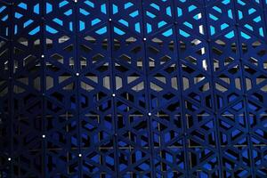 The texture of the cladding of a building made of metal aluminum panels with a carved pattern. Abstract background. photo