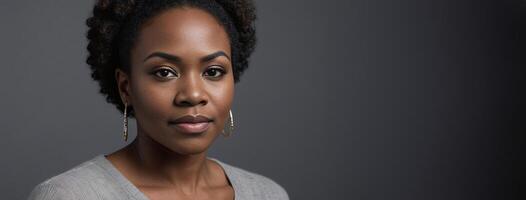 African American 2530 Years Woman Isolated On A Grey Background With Copy Space. photo